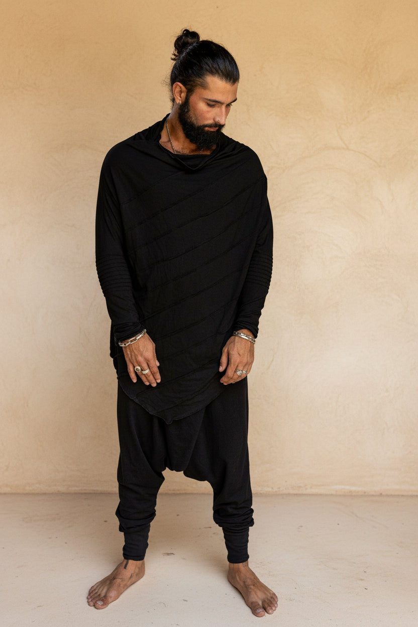 Man wearing bamboo oversized longsleeve shirt with unique stitch details & drop crotch bamboo harem pants